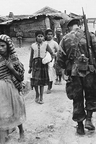 French patrol in Orleansville (Chlef) in 1957, little Algerian girls walking terrified barefoot