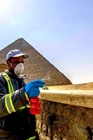 Un trabajador desinfecta el entorno de las pirámides en Egipto