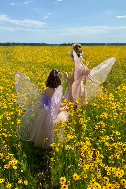 Children playing among flowers, representing the pure intentions and emotions of childhood