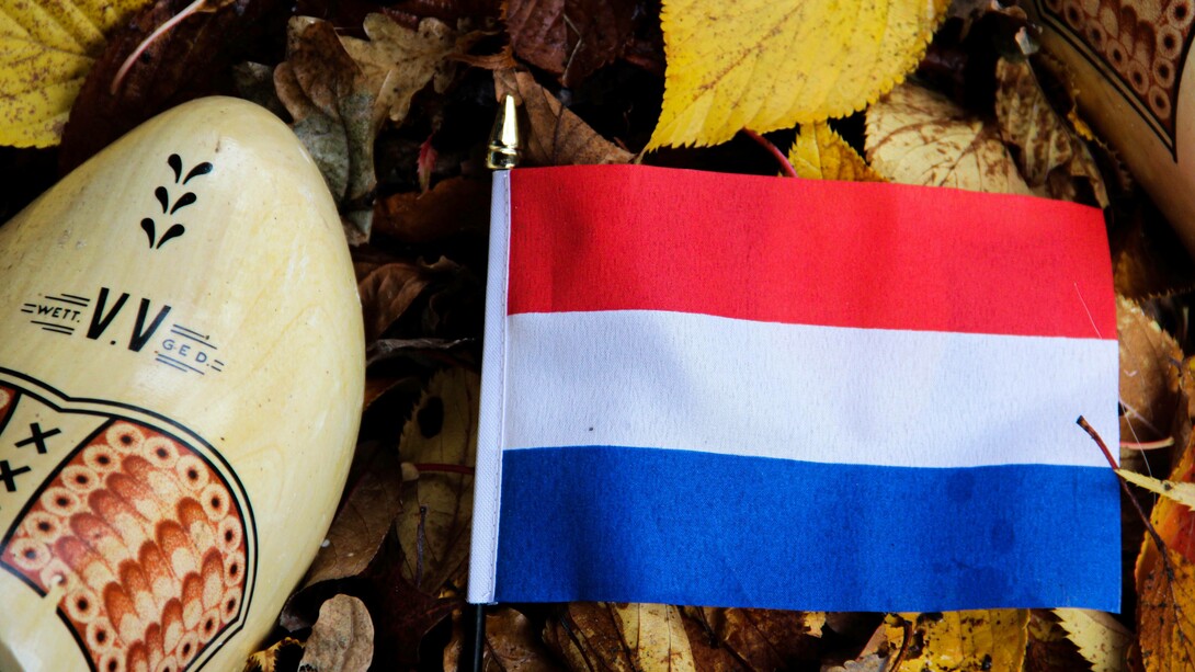 The flag of the Netherlands along with its iconic cultural footwear the clog