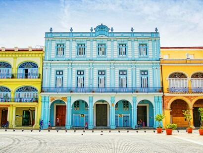 A beautifully restored, brightly colored colonial building in Havana, illustrating the city's ongoing efforts to preserve its historic architecture and vibrant aesthetic