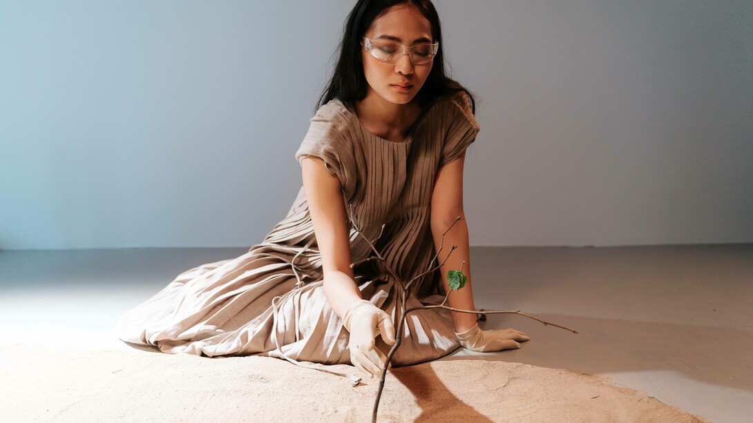 A woman taking care of a tree is a symbol of the last chance to avoid a climate disaster