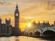 A golden sunset casting long shadows over Westminster and the Thames, representing the fading glow of Britain’s former global authority