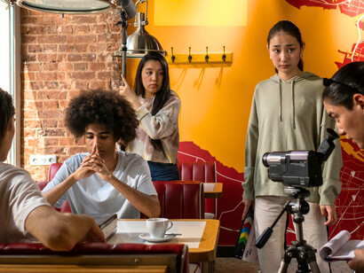 A group of filmmakers working with male actors, symbolising the industry’s power to shape masculinity through selective storytelling