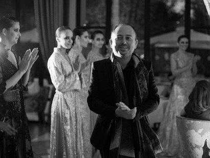 Fashion designer Albert Oiknine being applauded by his models after a recent expo
