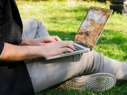 A young graduate browses job listings online, feeling overwhelmed by post-college uncertainty and the pressure of finding purpose