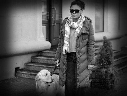 The blind woman starts her journey into the world with her seeing-eye-dog leading the way