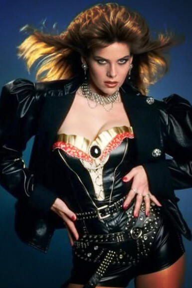 A woman embraces the bold spirit of 1980s fashion with voluminous hair, a leather jacket, and a confident sense of individuality