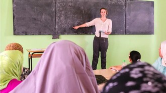 A volunteer worker teaching English in Morocco. Learning foreign languages, such as French and English, has given Moroccans access to different cultural viewpoints and improved the nation's capacity for cultural adaptation