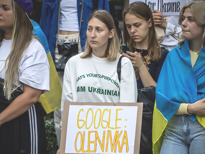 Amidst the streets of Germany, a fervent protest takes place, where demonstrators wave Ukrainian flags passionately, denouncing the conflict in Ukraine