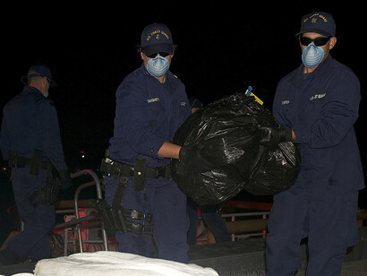 U.S. Coast Guardsmen offload more than $12 million in seized cocaine at Coast Guard Sector St. Petersburg, Florida, following a counter drug operation under Operation Martillo in November 2013