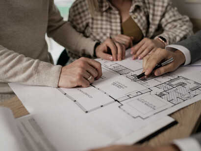 Architects looking at the plans for a building, mirroring the teamwork that defines adaptive, sustainable design