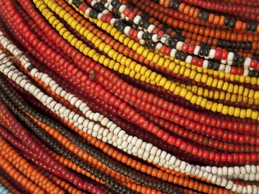 Vivid beads layered to create a unique style, symbolising how the beads communicate background 