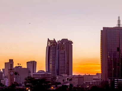 Johannesburg cityscape at sunset, with business buildings glowing in the evening light, South Africa