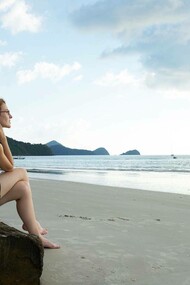 A woman alone on the beach as she manages silence 