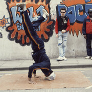 Beezer, Bristol BBoys head spinning in front of 3D's and Z Boys’ Wild Bunch Rocit, 1983, photographic print on paper, Broadmead, Bristol, 21 x 29.7cm
