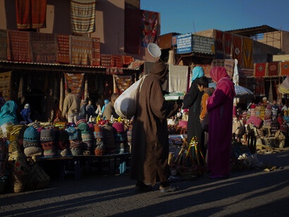 People are busy buying things at a market in Morocco. The existence of various languages here has significantly impacted Morocco's cultural diversity and national identity
