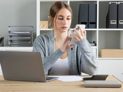 A woman working from home at her desk, focusing on remote work while nurturing her energy and striving for a balanced work-life routine