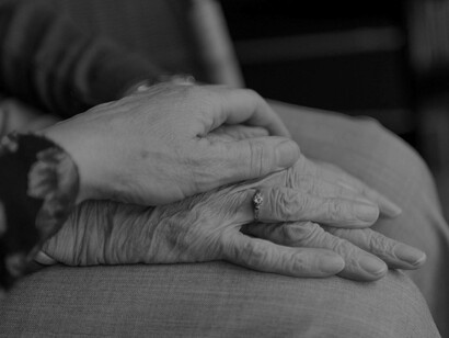 A comforting hand reaching out to a person who has Parkinson's disease