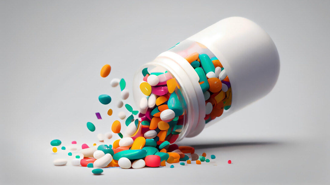 Medicine bottle spilling colorful pills 