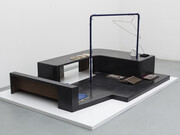 Magali Reus, In Place Of (Sundries), 2015. Black waxed and clear waxed Jesmonite, black waxed polyester resin, silicone rubber, polyurethane rubber, latex, powder coated laser cut steel, phosphated and powder coated steel, steel rod, magnets, sanded paper, polyurethane plastic, fabric, air brushed polyester resin, polyurethane resin, putty wax, vinyl. Part 1: 141 x 188 x 90 cm 