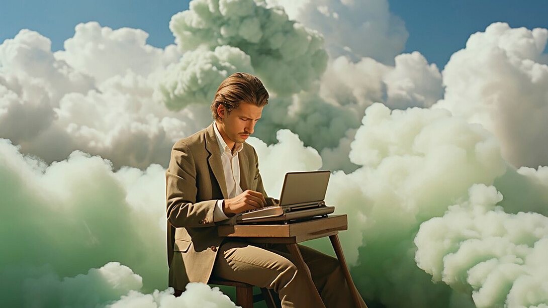 A man typing on his computer, surrounded by soft, floating clouds