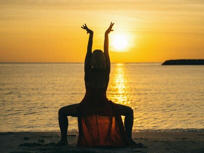 Mulher dança na praia. E você? Está disposta a caminhar com reverência hoje?