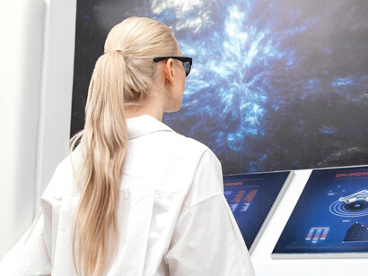 Woman interacting with digital monitors, highlighting AI technology and automation in action