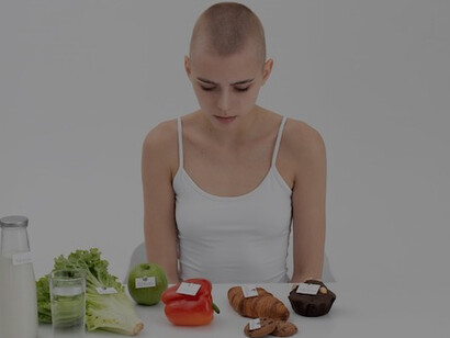 A young woman stands beside food items marked with calorie numbers, showcasing fake health claims and detox diets, demonstrating the influence of cognitive biases in health