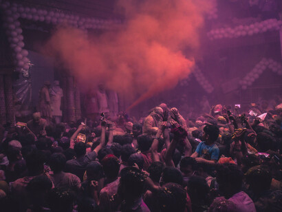 A lively crowd celebrating the Hindu Holi festival with color, music, and joy