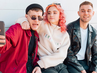 Young friends smiling and looking at each other, representing the camaraderie and shared experiences of millennials