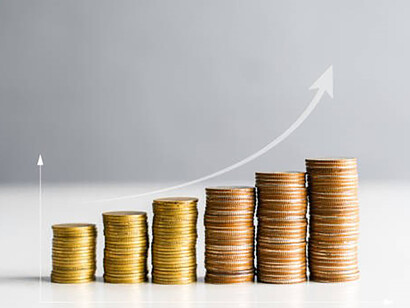 Nestled within a coin stack lies the embodiment of a flourishing economy, nurtured by strategic financial investments and propelling sustained economic growth