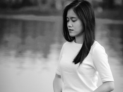 A girl sitting by the river, the law of timelessness and the spiritual being