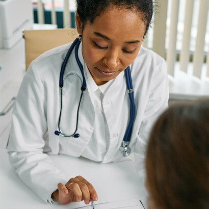 A healthcare professional provides counsel to a concerned patient, reminding us that a great nation must ensure health security for all