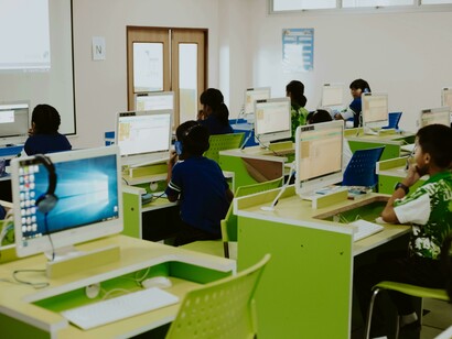 Students using computer-based learning tools in a modern classroom environment