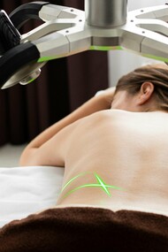A patient receiving a non-invasive laser-assisted procedure, reflecting the growing preference for treatments with minimal downtime