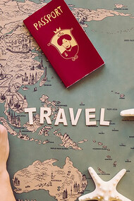 Capture attention with a cropped image of a hand holding a magnifying glass over stamps