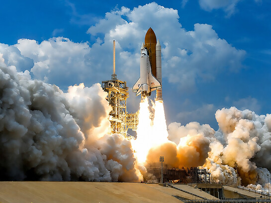 At NASA’s Kennedy Space Center in Florida, space shuttle Atlantis launches through clouds of smoke and steam on its STS-125 mission to service the Hubble Space Telescope. The 11-day mission included five spacewalks to upgrade Hubble with advanced scientific instruments and extend its operational life