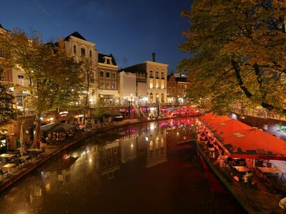 Utrecht's river flows gracefully through the city, lined with tall buildings and scenic canals, creating a perfect blend of urban and natural beauty, Netherlands