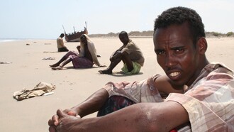 Somali migrants near a shipwreck