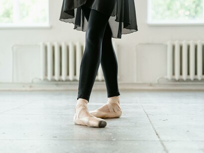 A person wearing black and ballet shoes 