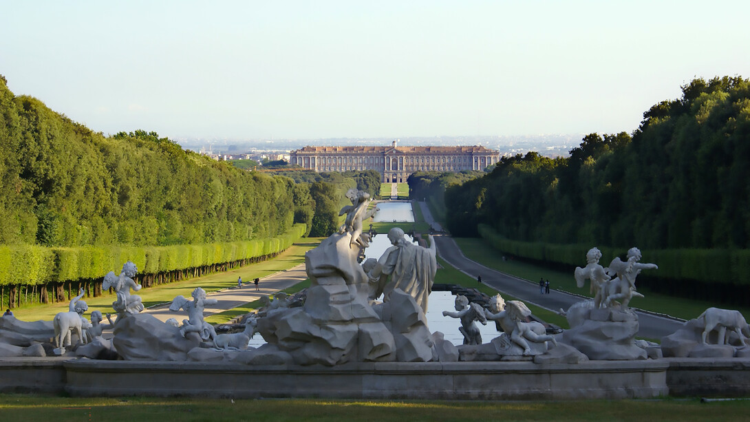 The Royal Palace of Caserta seen from the fountain of Venus and Adonis inside the Royal Park, Italy