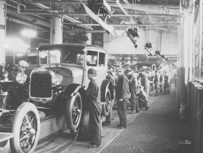 Factory workers in the auto industry install the parts for the cars