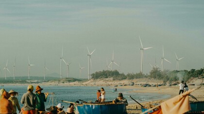 Renewable energy landscapes rise in sunlight while the shadows of heavy industry linger in the distance—a visual metaphor for the shifting balance of global power generation