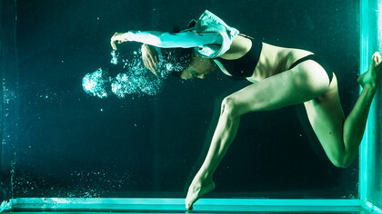 Experience the fitness revolution with a flexible woman gracefully dancing underwater—an invigorating exercise promoting holistic health and well-being