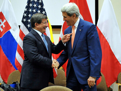 U.S. Secretary of State John Kerry and Turkish Foreign Minister Ahmet Davutoglu shake hands before a bilateral meeting amid a series of ministerial discussions at NATO Headquarters in Brussels, Belgium, on June 25, 2014