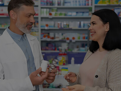 A compassionate pharmacist aids a patient by dispensing prescribed medication