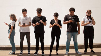 A gathering of individuals engrossed in their mobile phones