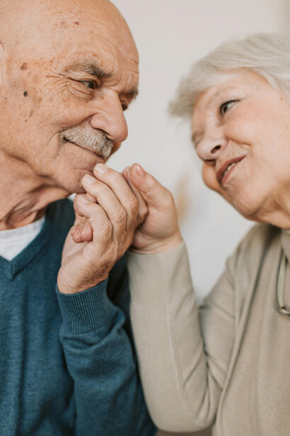 A lovely elderly couple holding hands, sharing a moment of intimacy and connection