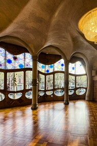 Barcelona, Spain, the interior of Casa Batlló featuring a decorative ceiling and large windows, showcasing Antoni Gaudí’s distinctive design style